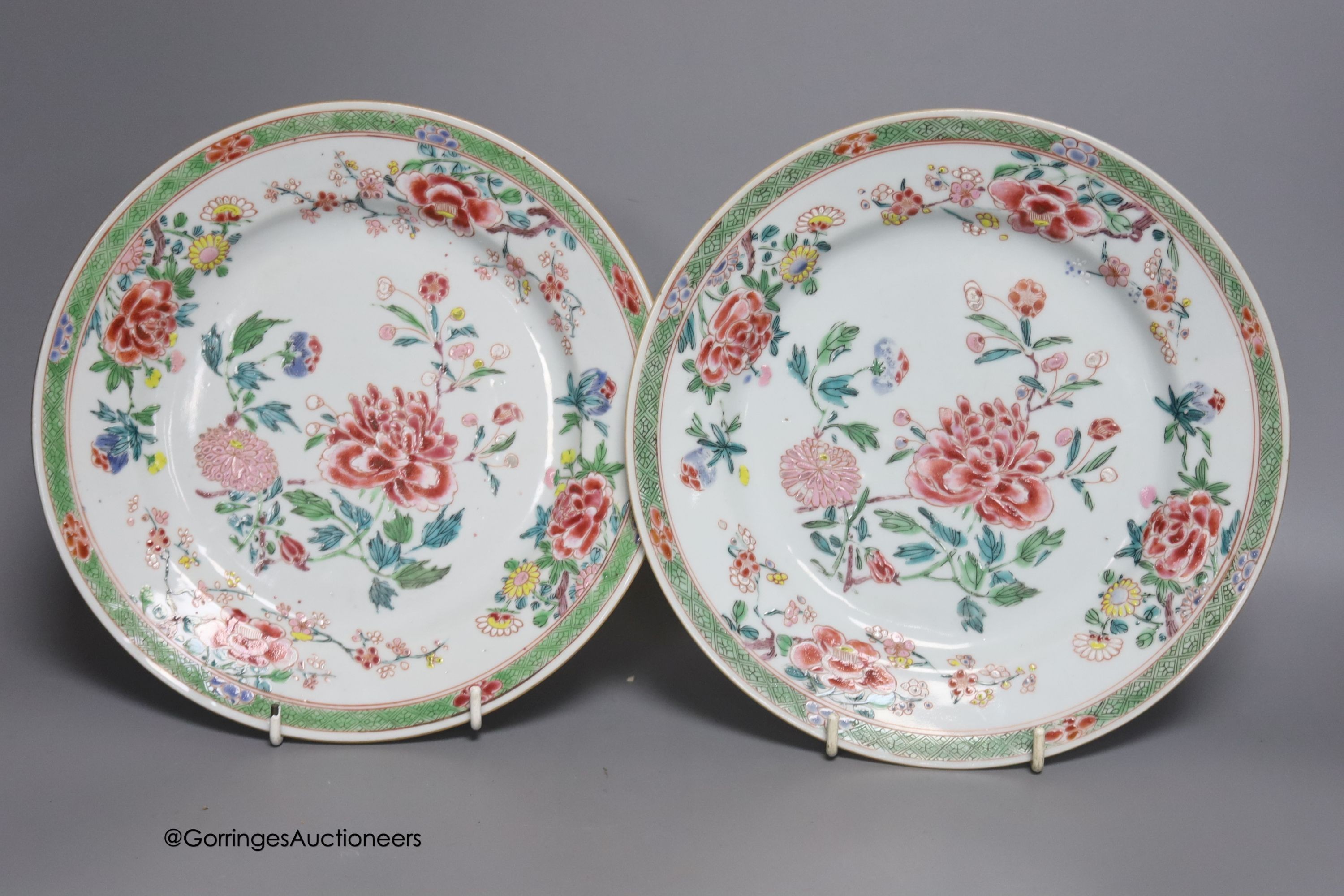 A 19th century Chinese famille rose bowl, two saucers and two 18th century Chinese famille rose plates 23cm